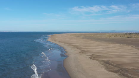 Beautiful-large-sandy-beach-Espiguette-la-Grande-motte-in-background-aerial